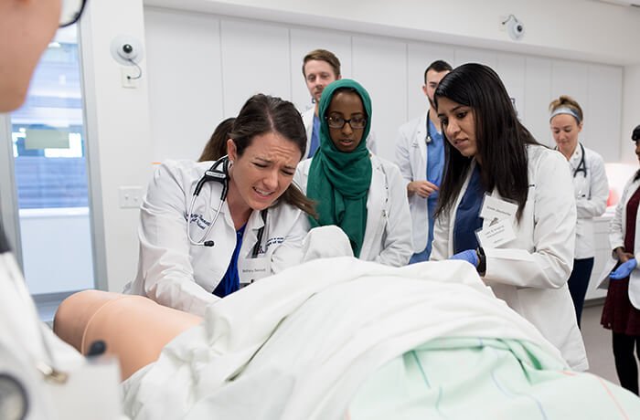 Medical Students Delivering a Baby from the Simulation Birthing Mannequin