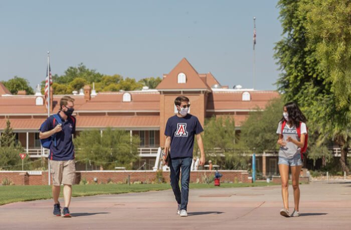 Three Students Walk through the Tucson Campus