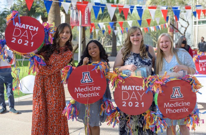 Four Students Hold Up Their Match Pinatas