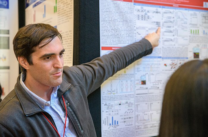 A Man Presents His Research at a Conference