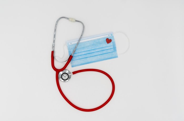 A stethoscope and a disposable mask with a heart