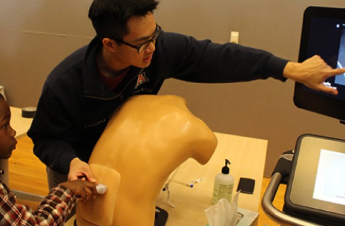 A Medical Student Demonstrates Ultrasound to an Attendee