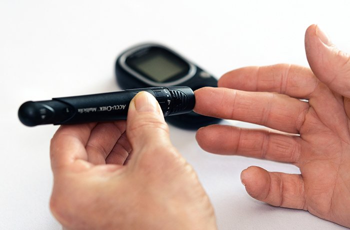 A person measures their blood sugar levels