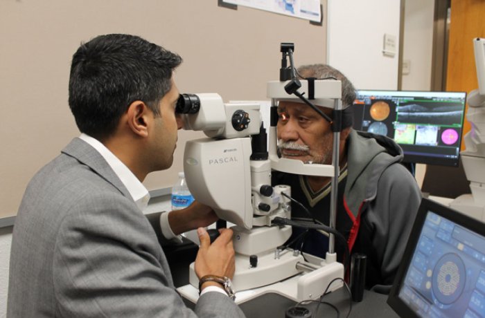 Dr. Amit Sangave performs eye exam. Photo courtesy of St. Vincent de Paul.