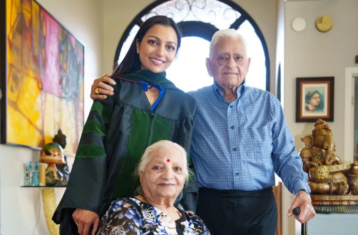 Graduate of University of Arizona College of Medicine – Phoenix, Maya Patel (left), poses for a photo with her grandparents Bhaichand Dholakia (right) and Pushpaben Dholakia (front) in her home in Scottsdale on May 7, 2022 (Photo Credit: Megan Mendoza/The Republic)