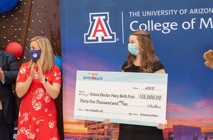 Mary Beth Putz Holds the Check from the Arizona Lottery