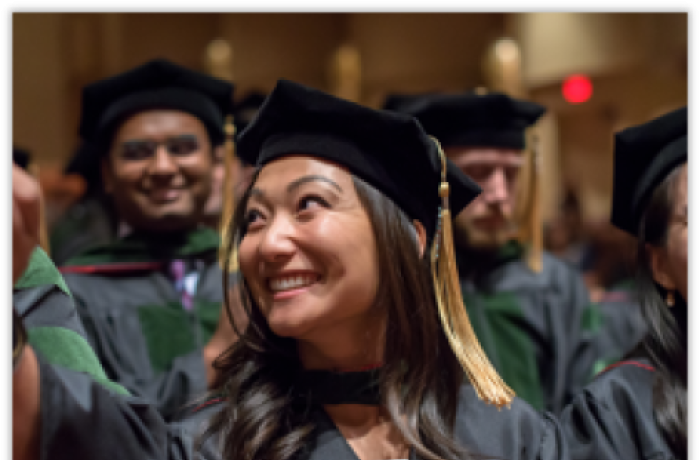 A Medical Student Smiles in Her Cap and Gown at Commencement 