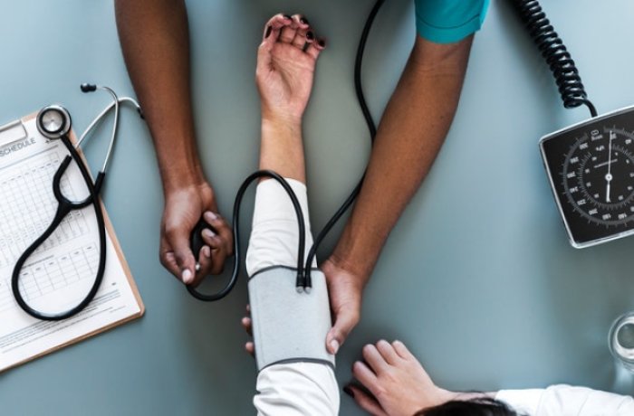 A Doctor Checks a Patient's Blood Pressure