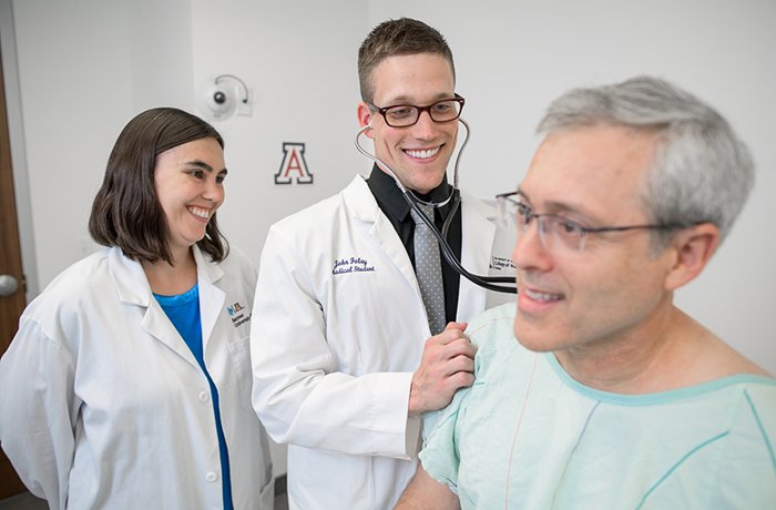 Medical Student Examines a Patient with a Faculty Member Watching