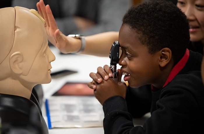 Medical Student Showing a Youth Equipment from the Center for Simulation and Innovation