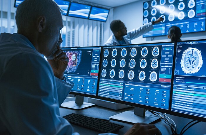 A Doctor Observes Skull X-Rays on His Computer