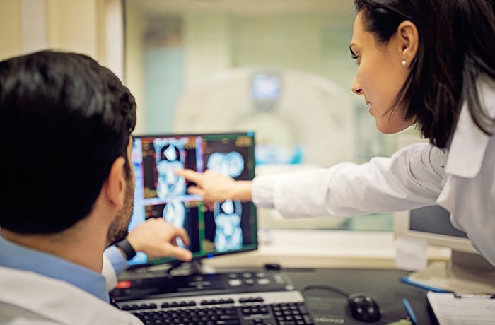 Two Doctors Look at Test Results on a Computer Screen