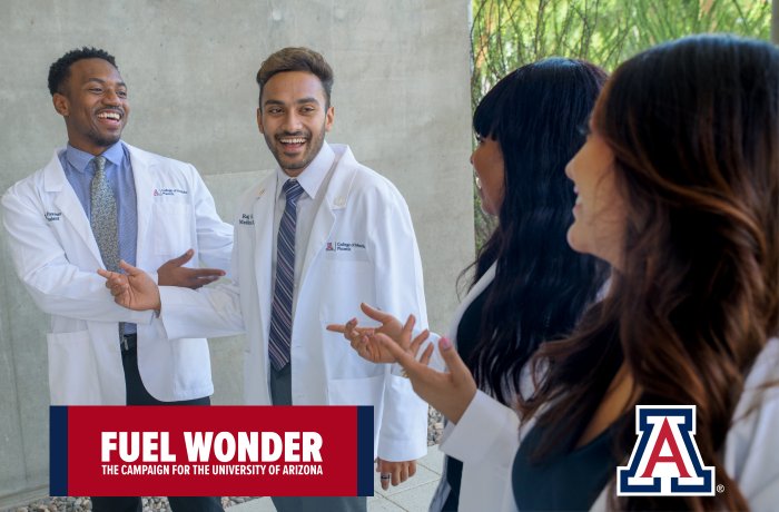 Four students talk outside of the Health Sciences Education Building