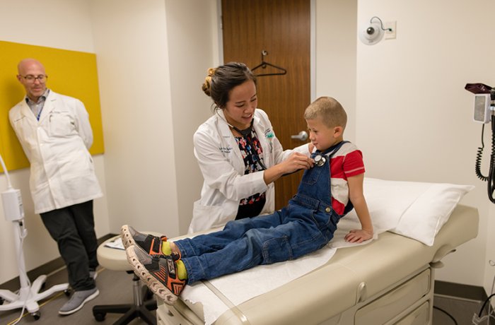 A medical student providing care to a pediatric patient