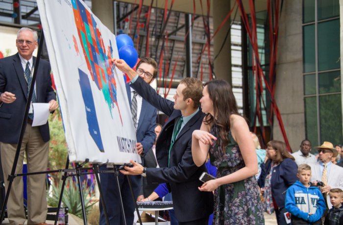 Andrew Albert, MD, and Catherine Hermann, MD, pin their "Match" at the Class of 2018 Match Day