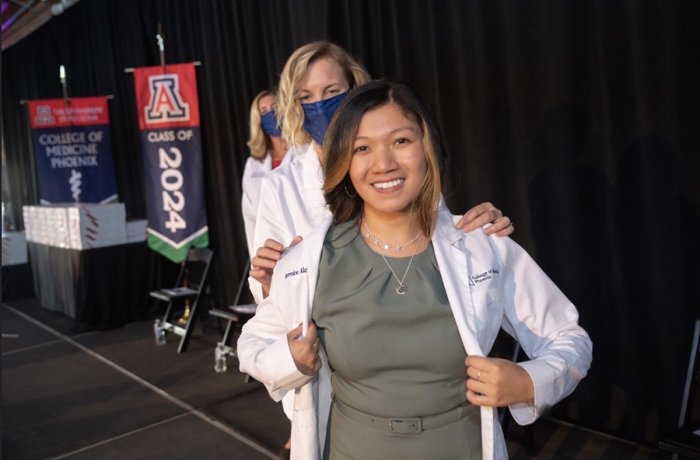 Bernice Alcanzo getting coated at the Class of 2024 White Coat Ceremony