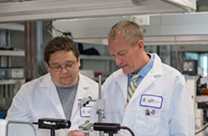 Dr. Zenhausern Works with Matthew Barrett in Their Lab