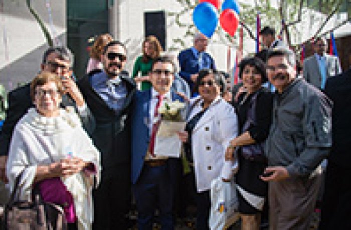 Victor Arce posing for a picture with family