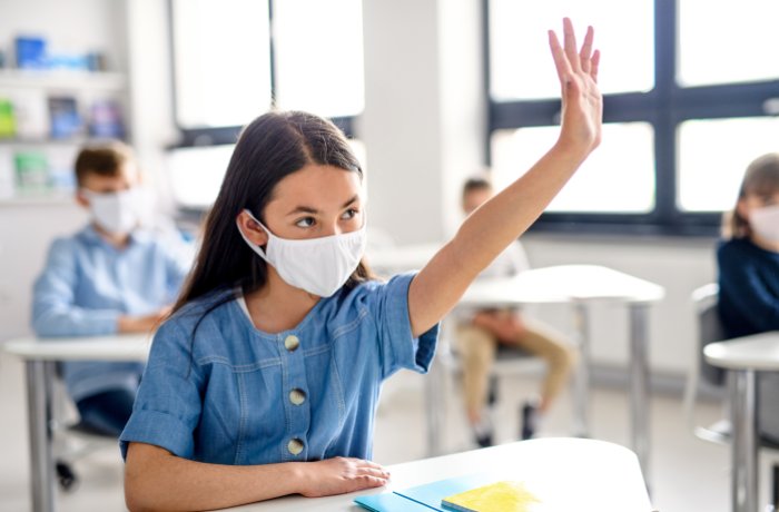 Child wearing mask in classroom 