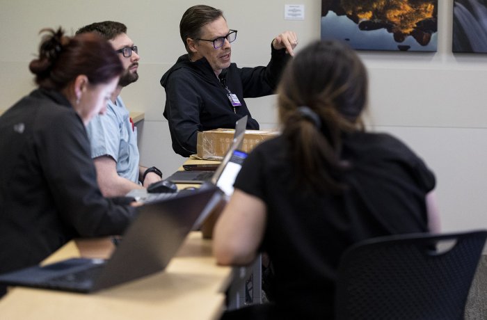 Robert Bina, MD, talks with medical students during a Neurosurgery Interest Group meeting