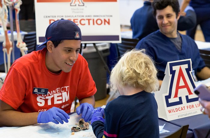 A Medical Student Works with an Attendee in the Simulation Center Zone