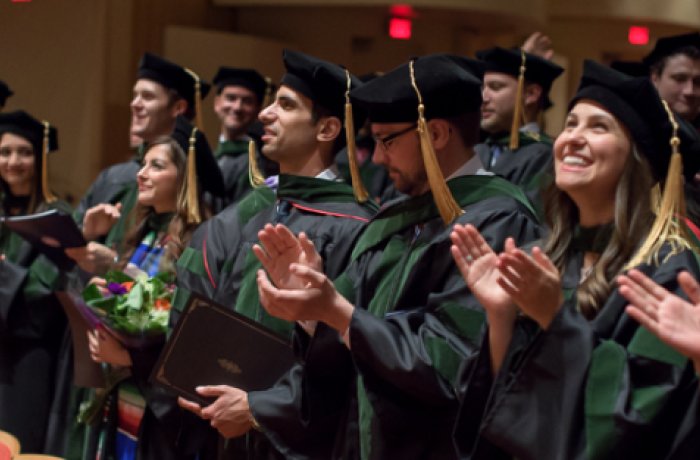 medical students in their caps and gowns at commencement