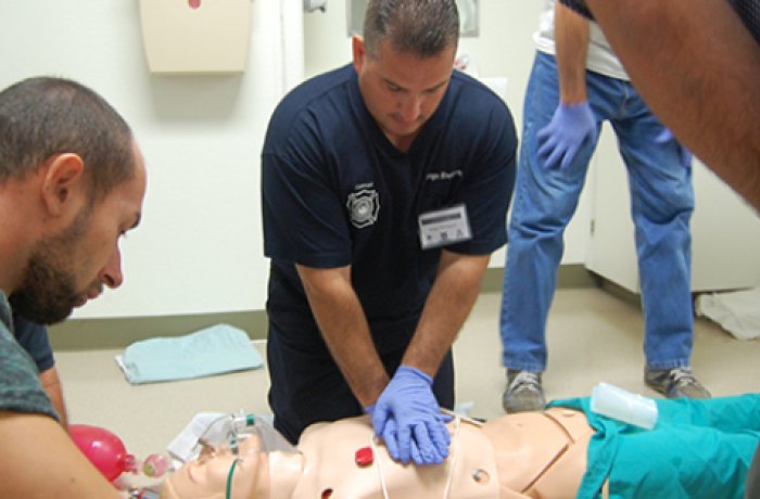 A Medic Performing CPR on a Mannequin