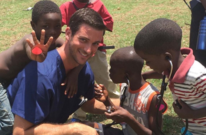 Britton Donato smiling and posing with children