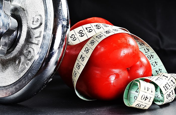 A weight, measuring tape and a red pepper