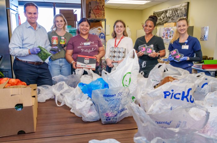 Steven Brown, MD, Allie Knox, staff, and residents stock the Banner Family Food Pantry