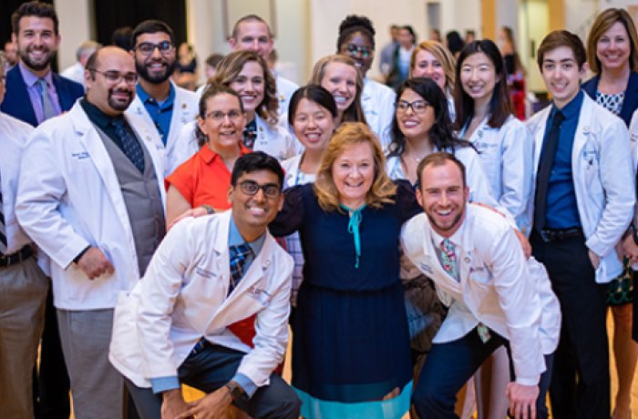 gold humanism society inductees pose for a group photo with faculty