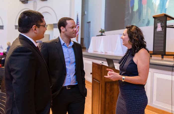 Dr. Cheryl O'Malley (Right) Talks with Two Graduates at the Ceremony