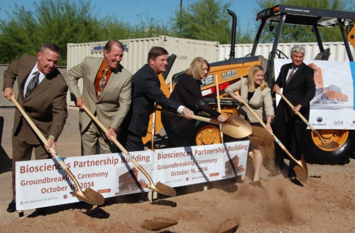 Leaders shoveling dirt at groundbreaking