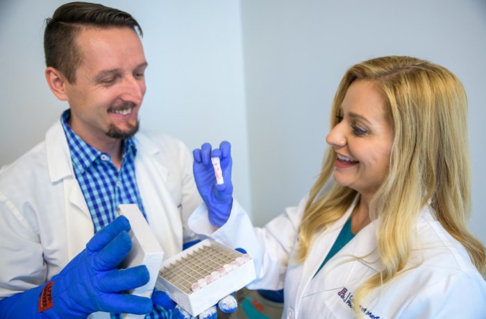 Melissa Herbst-Kralovetz Examines a Sample with Paweł Łaniewski, PhD