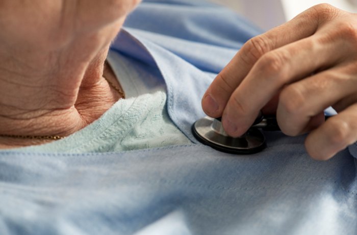 Physician listens to patient's heart