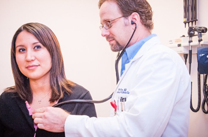 doctor using stethoscope on a patient 