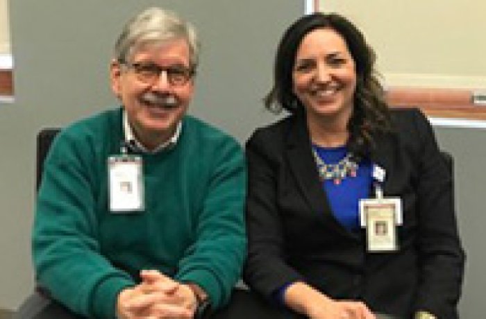 Drs. Leibowitz and O'Malley sitting down together, smiling