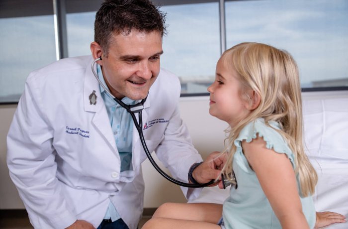 A UArizona College of Medicine – Phoenix medical student works with a pediatric patient in the Center for Simulation and Innovation