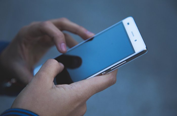 A person scrolls through their smartphone