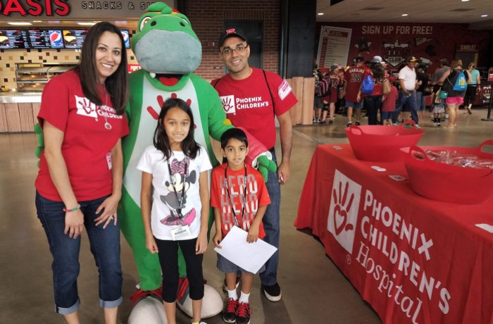 Dr. Rastogi and family at a Diamondbacks game volunteering for Phoenix Children's Hospital