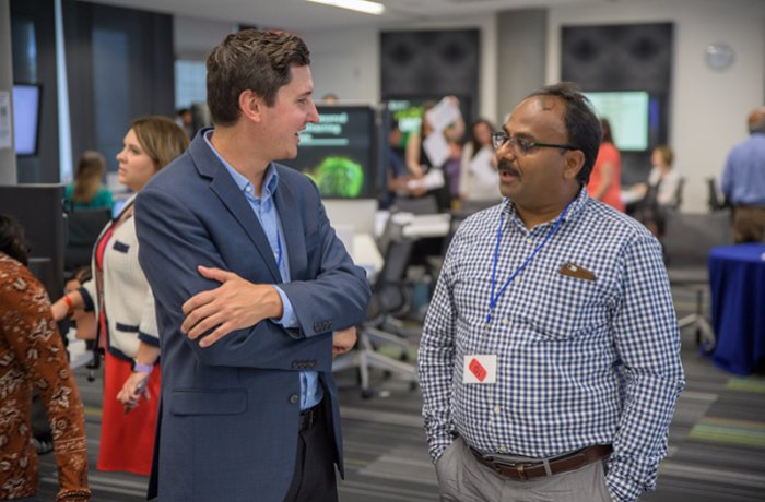 Tim Marlowe, PhD, Talks with an Attendee at the Research Office Open House