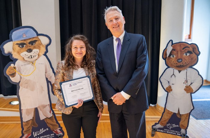 Brittani Miller, MD, receiving the John Mattox, MD, Award from Dean Guy Reed, MD, MS