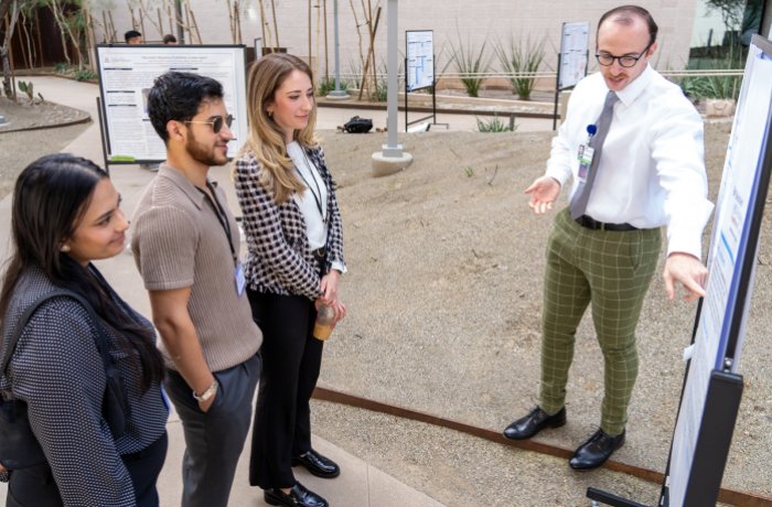 Sean McCauley discusses his Scholarly Project with fellow medical students at the symposium