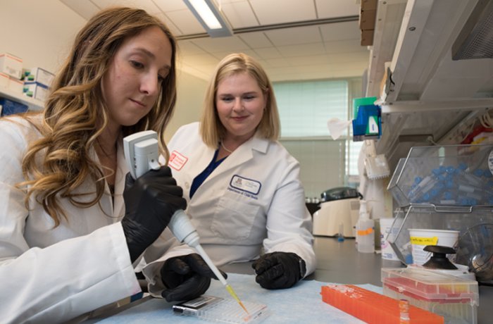 Theresa Thomas, PhD, with Caitlin Hair, Working in the Lab