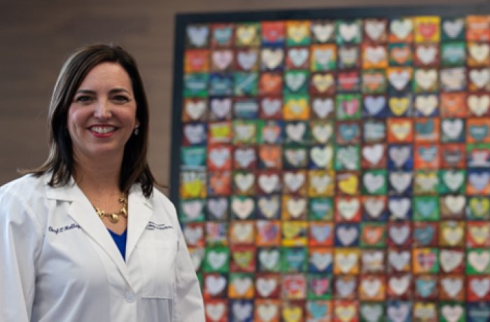 Dr. Cheryl O'Malley displaying artwork