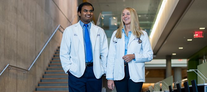 Two Medical Students Walking through the Library