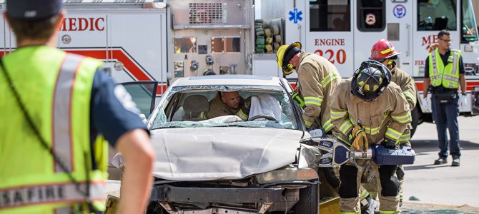 Firefighters Work the 'Jaws of Life' on a Damaged Motor Vehicle Firefighters Work the 'Jaws of Life' on a Damaged Motor Vehicle
