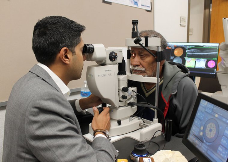 Dr. Amit Sangave performs eye exam. Photo courtesy of St. Vincent de Paul. Dr. Amit Sangave performs eye exam. Photo courtesy of St. Vincent de Paul.