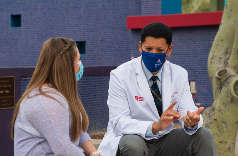 Wayne Franklin, MD, talks with a patient outside Phoenix Children's Wayne Franklin, MD, talks with a patient outside Phoenix Children's
