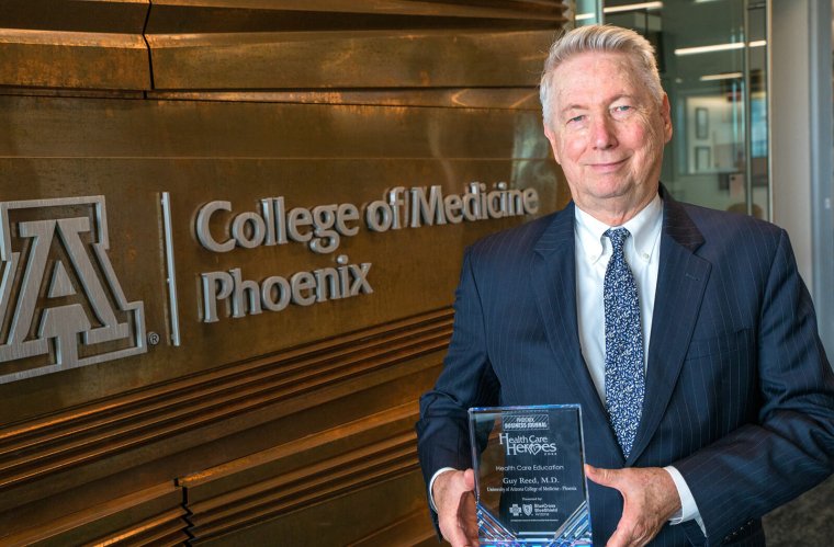 Dean Guy Reed, MD, MS, with his Health Care Heroes award Dean Guy Reed, MD, MS, with his Health Care Heroes award